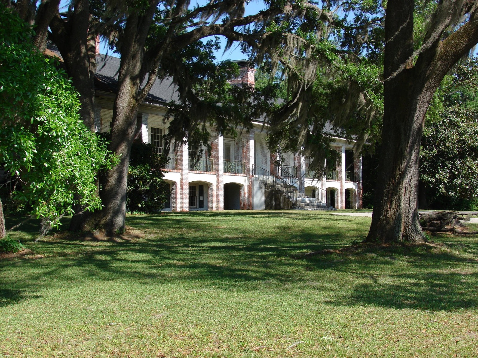 Live oaks and the historic house on the shrine grounds